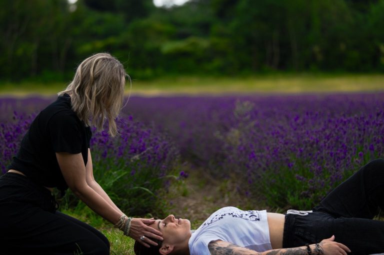 Photoshoot giving a demonstration of bodywork during breathwork Clare using bodywork on a client - photoshoot