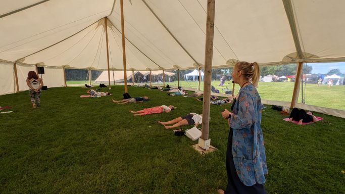 Clare guiding a group through a breathwork practice